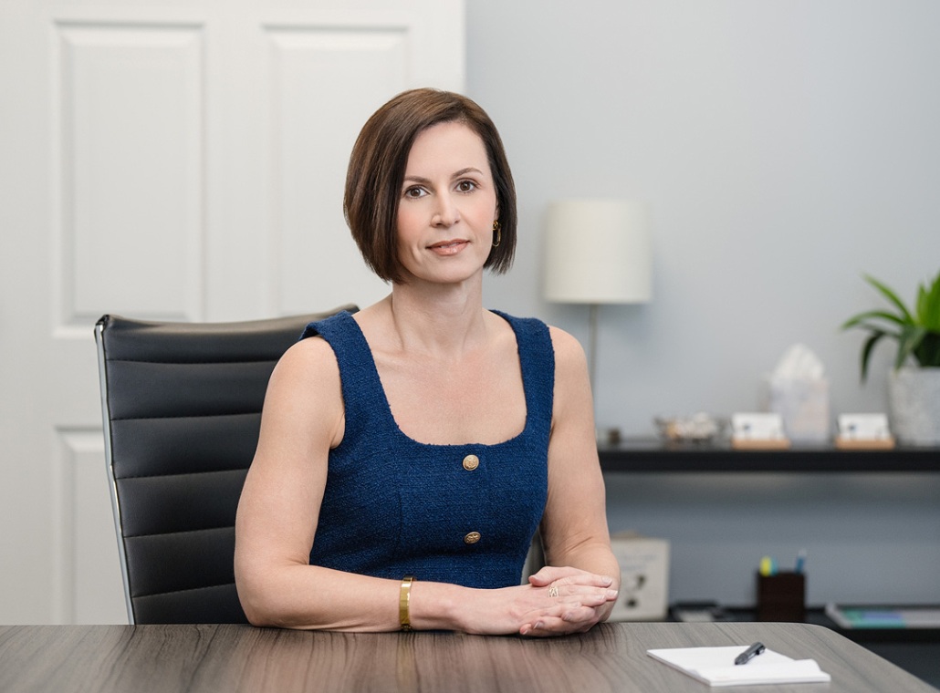 A headshot of Oak City Family Law founding attorney Katherine Frye sitting at her desk.